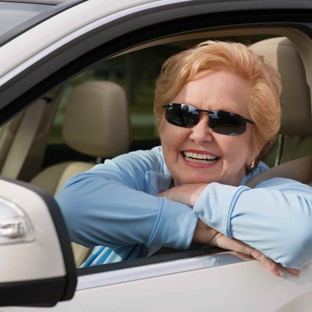 older woman in driver's seat of vehicle